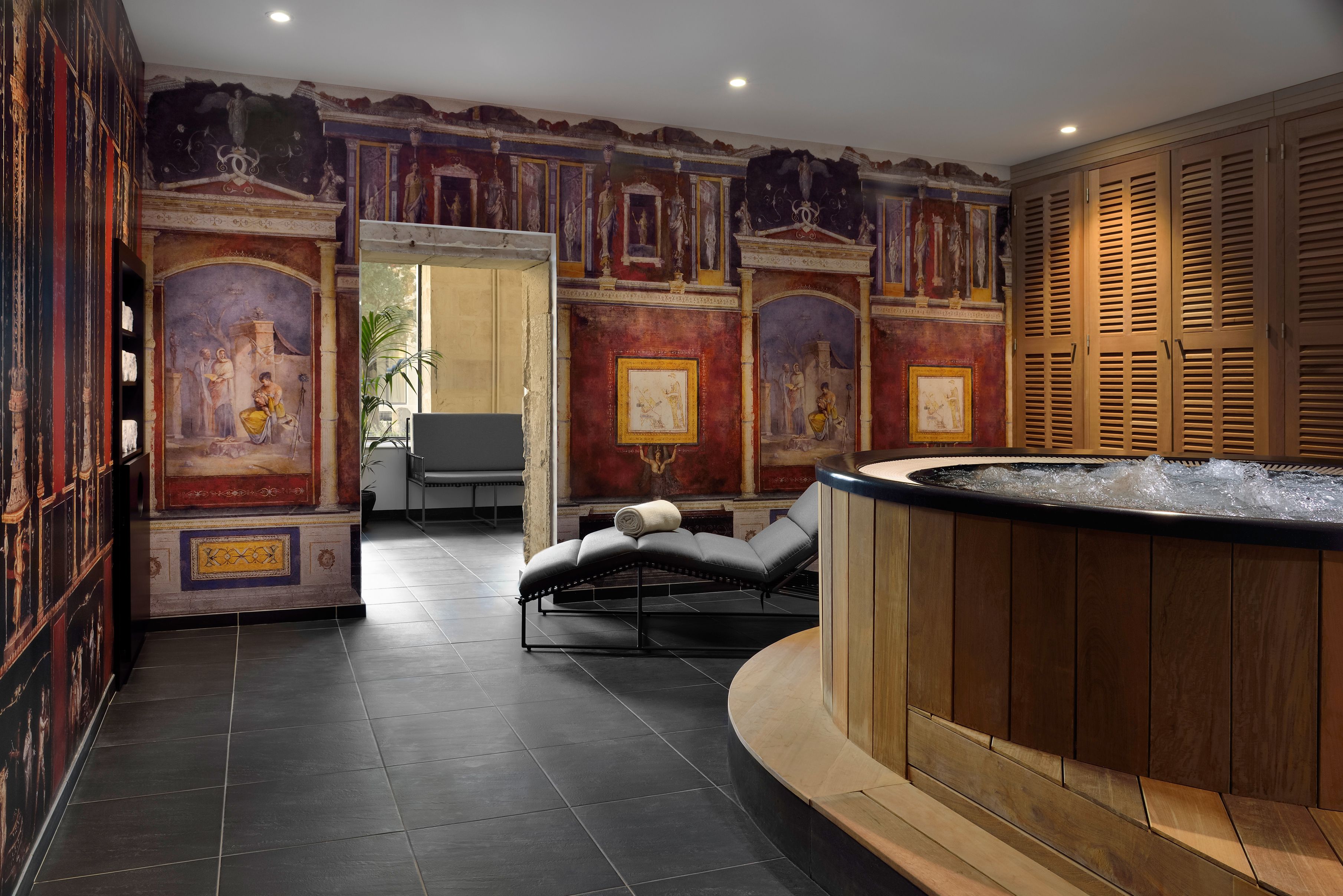 a room with a hot tub and a bench