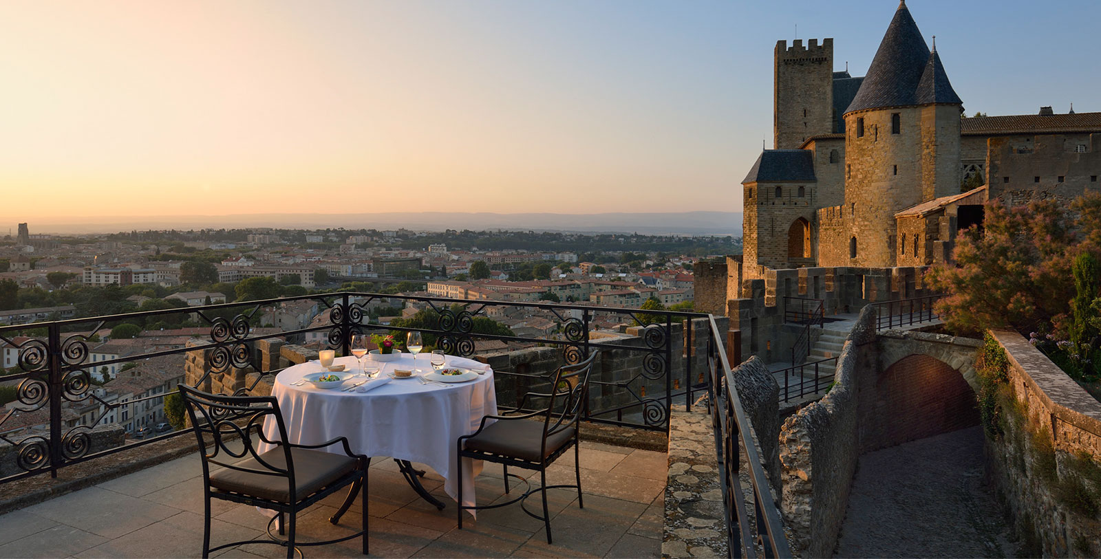 a table set up on a balcony overlooking a city
