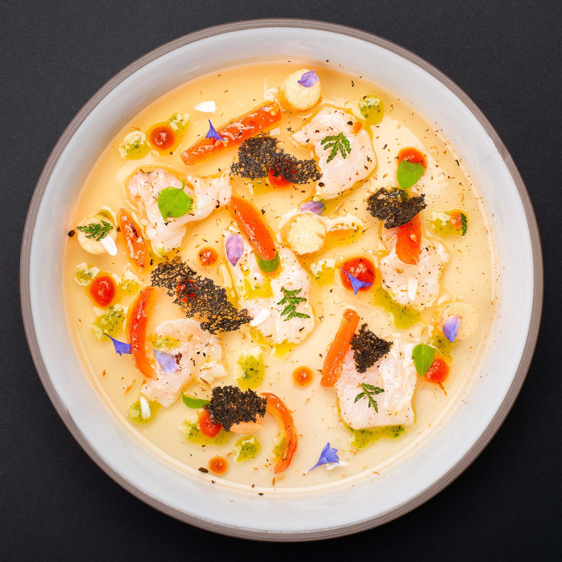 a bowl of soup with vegetables and meat