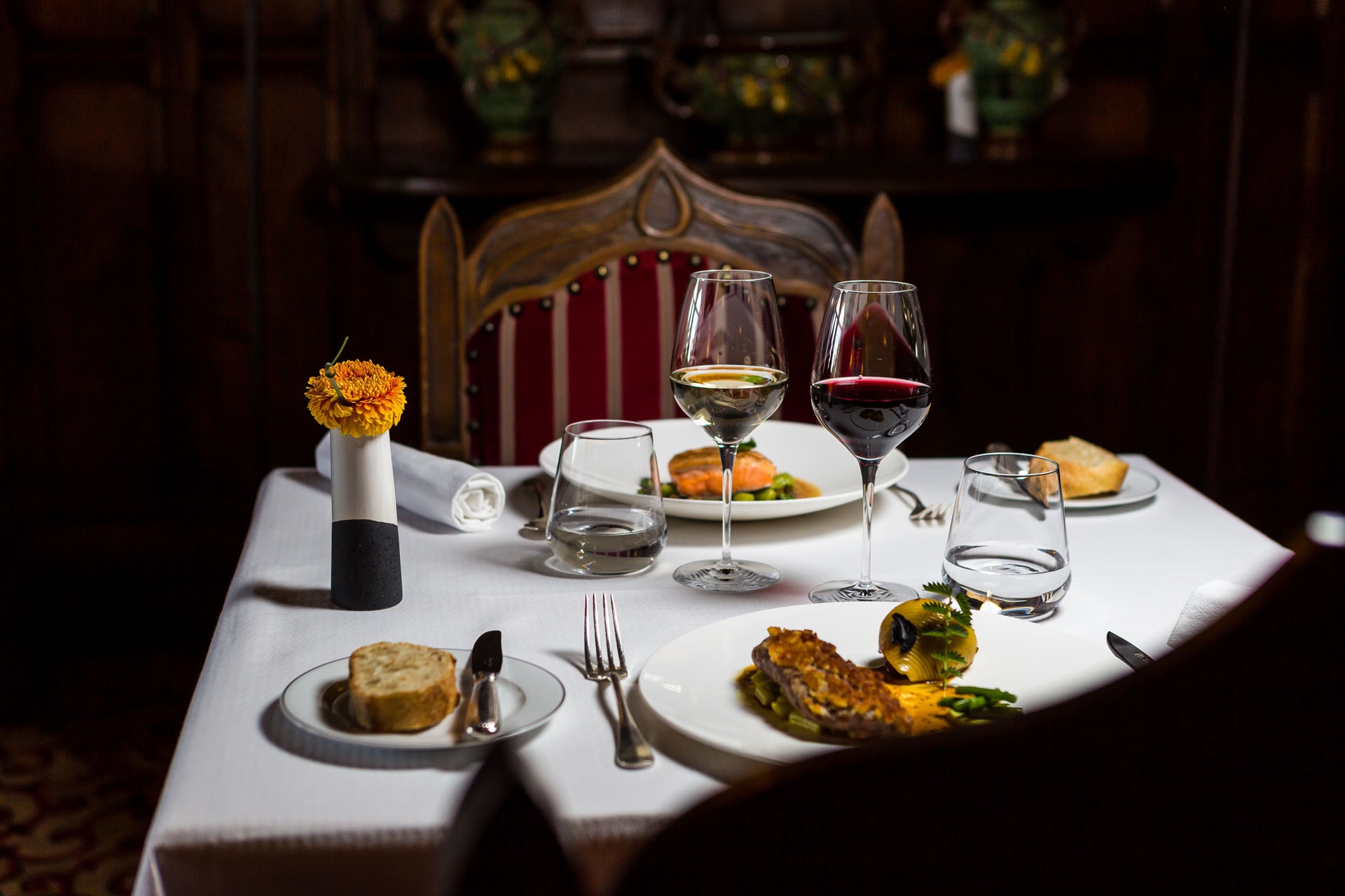 a table with food and wine glasses