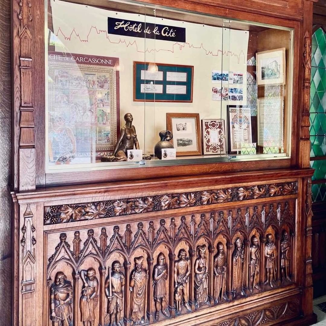 a wooden display case with statues and a window
