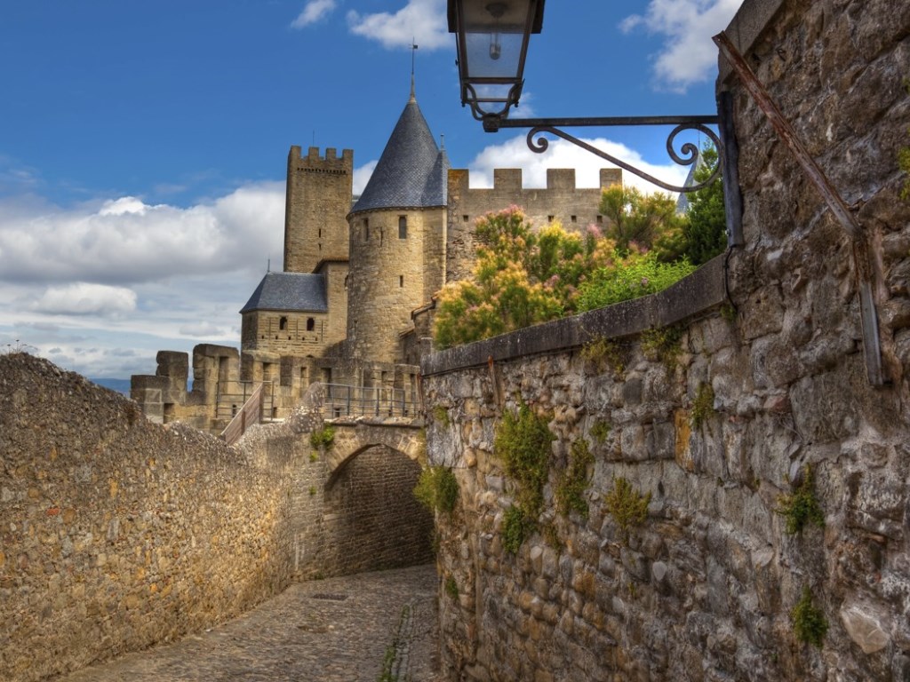 a stone wall with a stone wall and a castle
