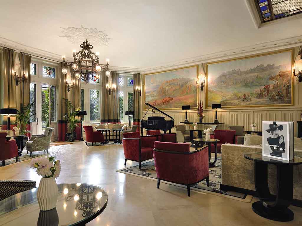 a room with a piano and chairs