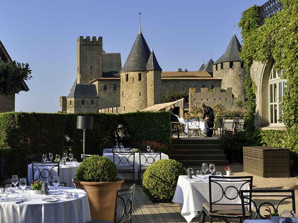 a restaurant with a castle in the background