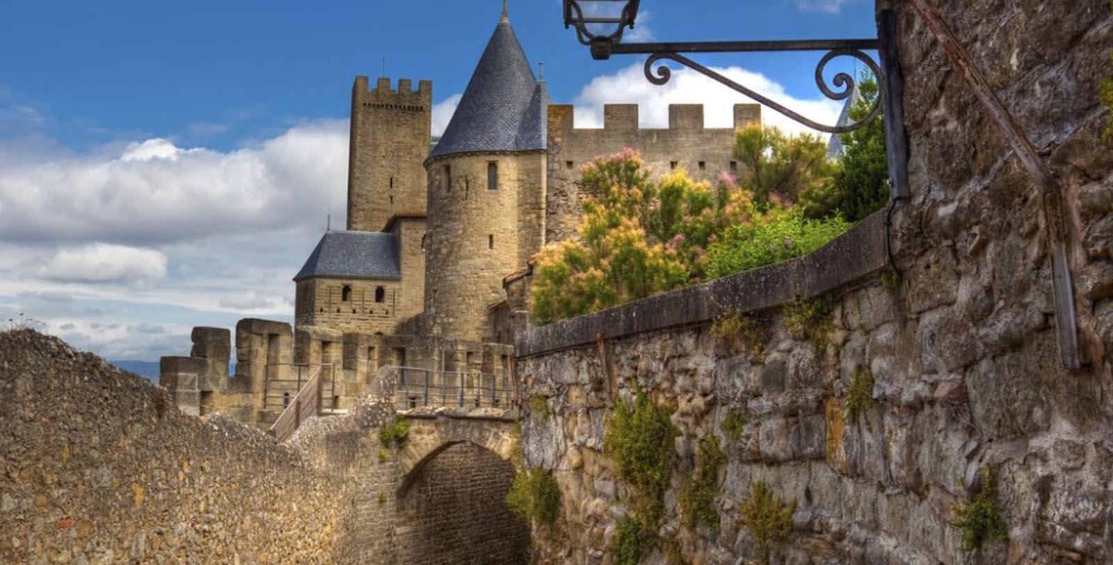 a stone wall with a bridge and a castle