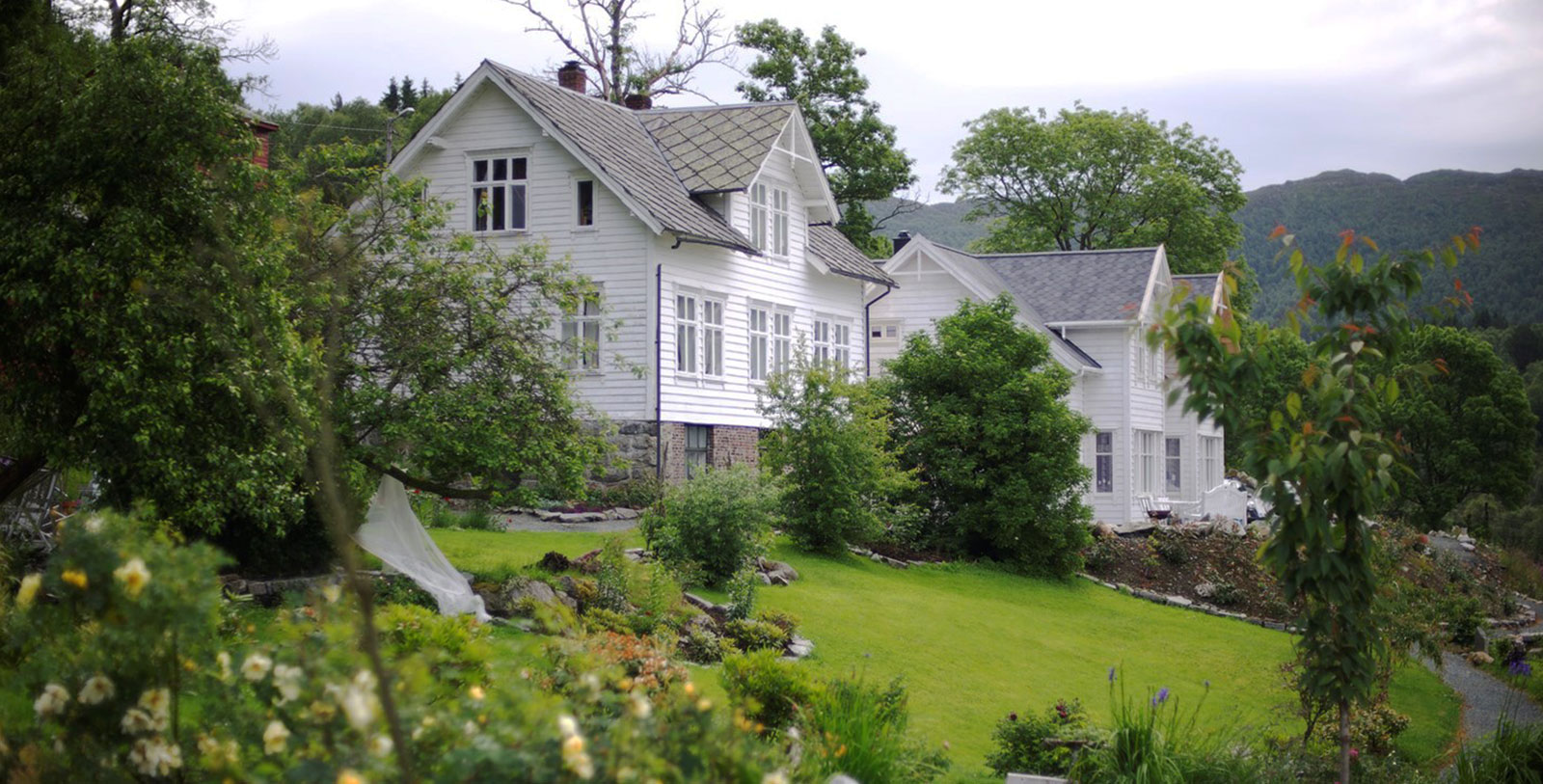 a white house with trees and grass