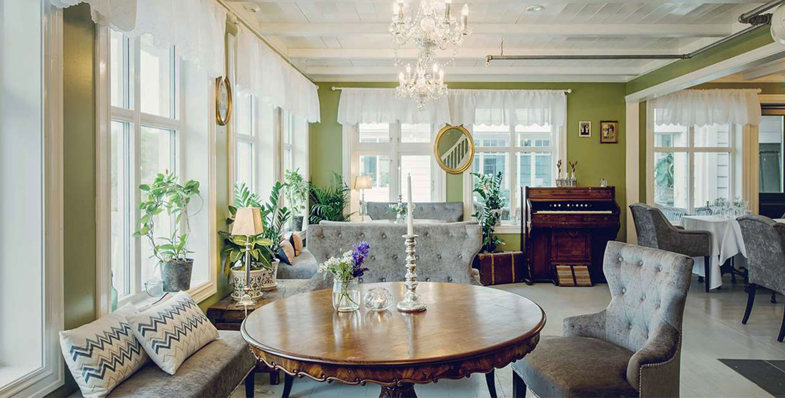 a living room with a chandelier and a table