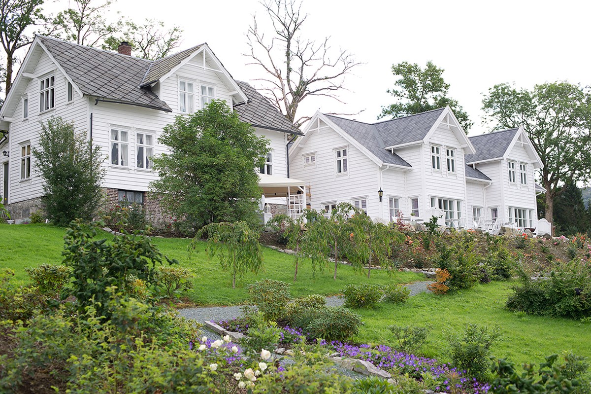 a large white house with a garden