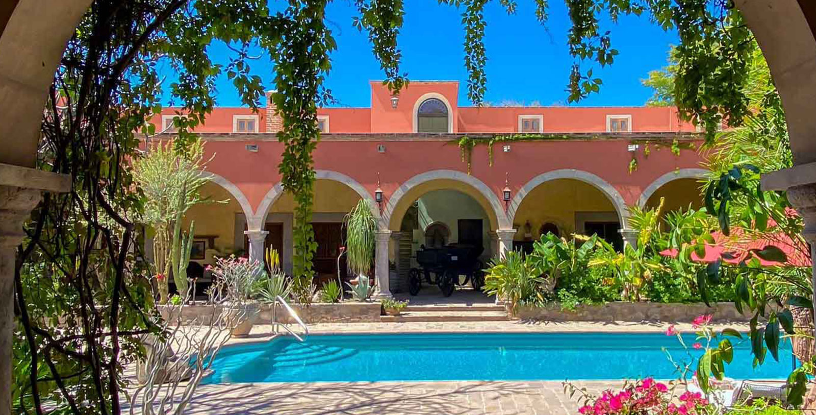 a pool with arches and arches in front of a building
