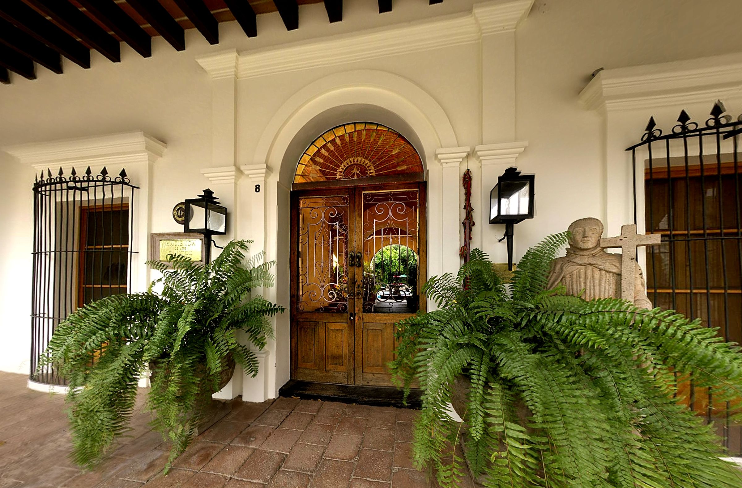 a front door of a building with a statue and a statue