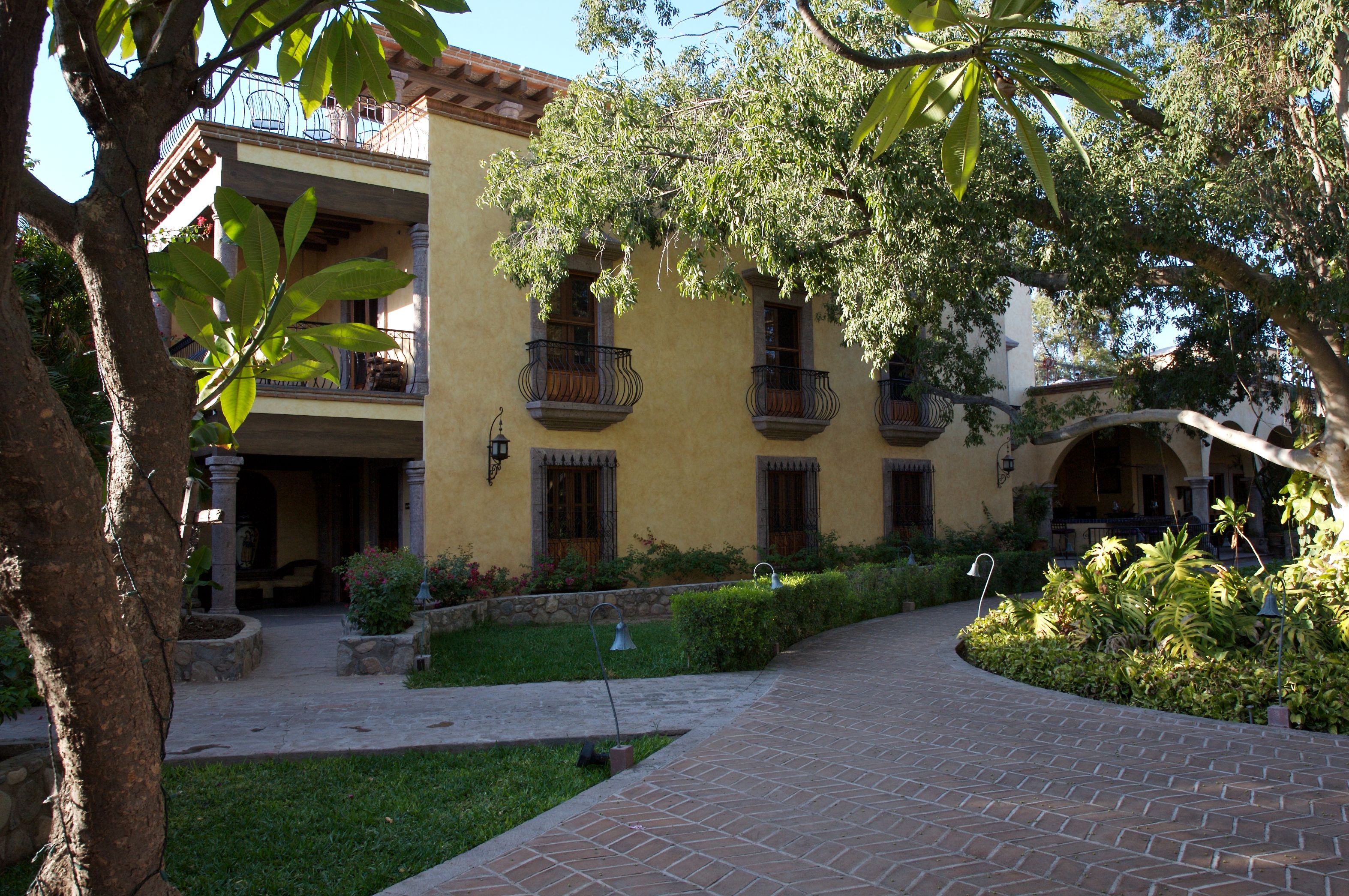 a building with a walkway and trees