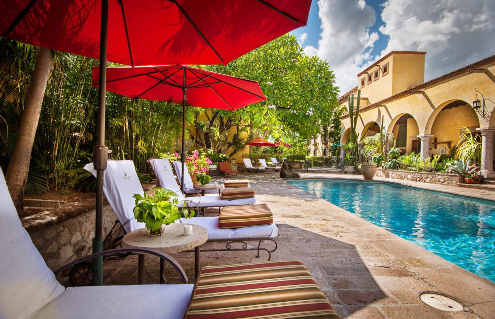 a pool with chairs and umbrellas