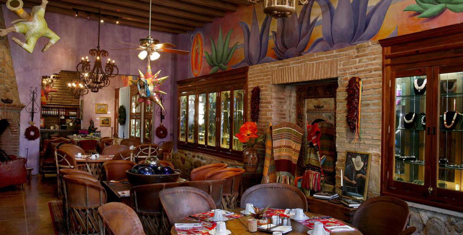 a room with a fireplace and tables