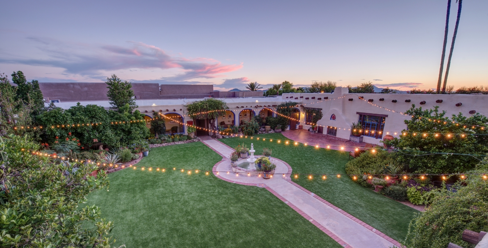 a courtyard with lights and a fountain