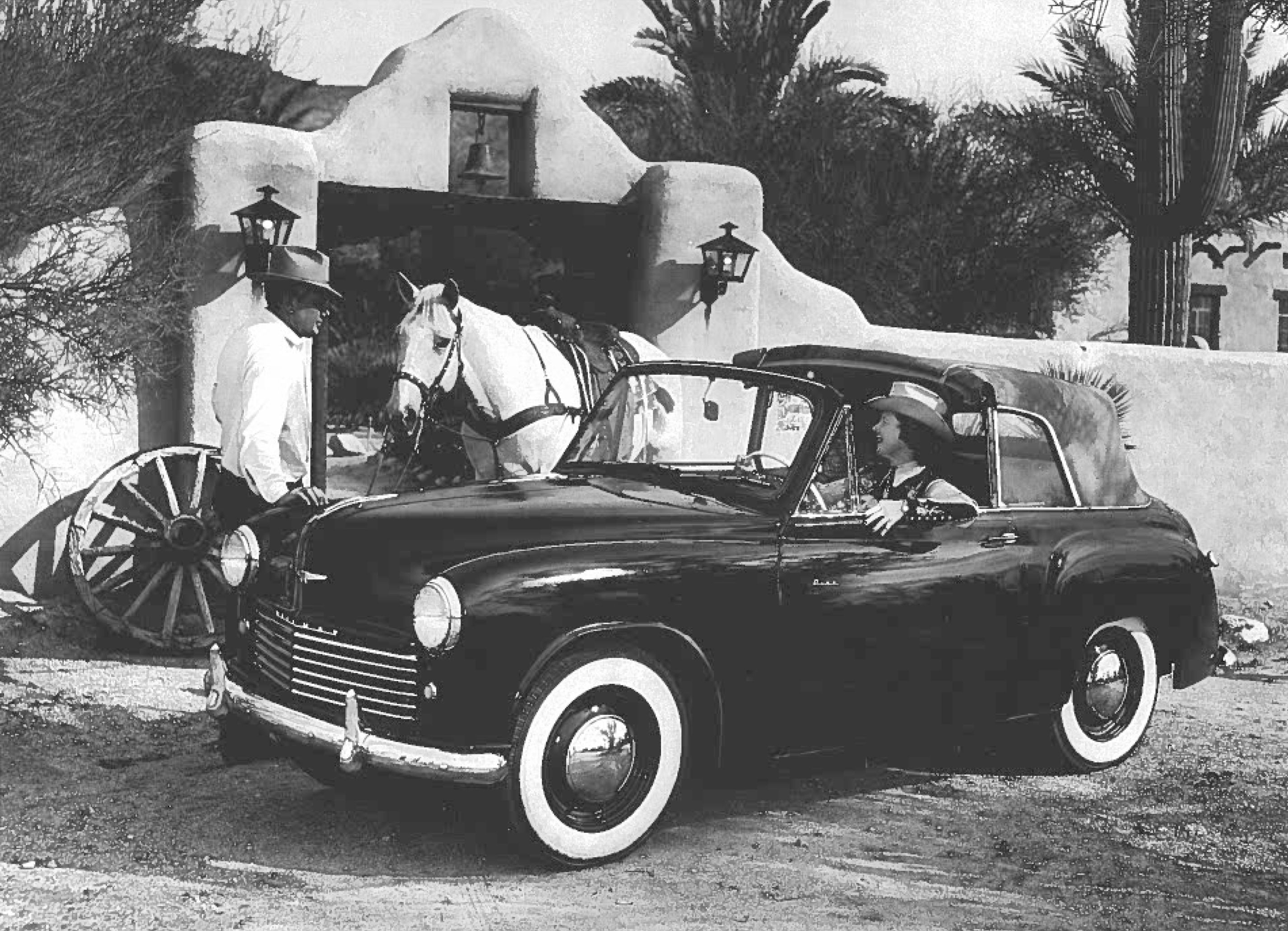 a black and white photo of people in a car