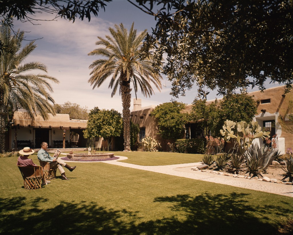 a group of people sitting on chairs in a courtyard