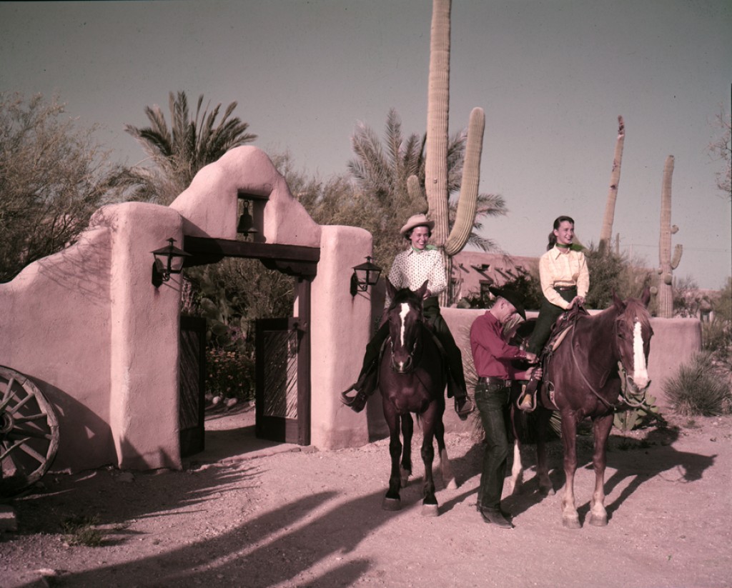 a group of people riding horses