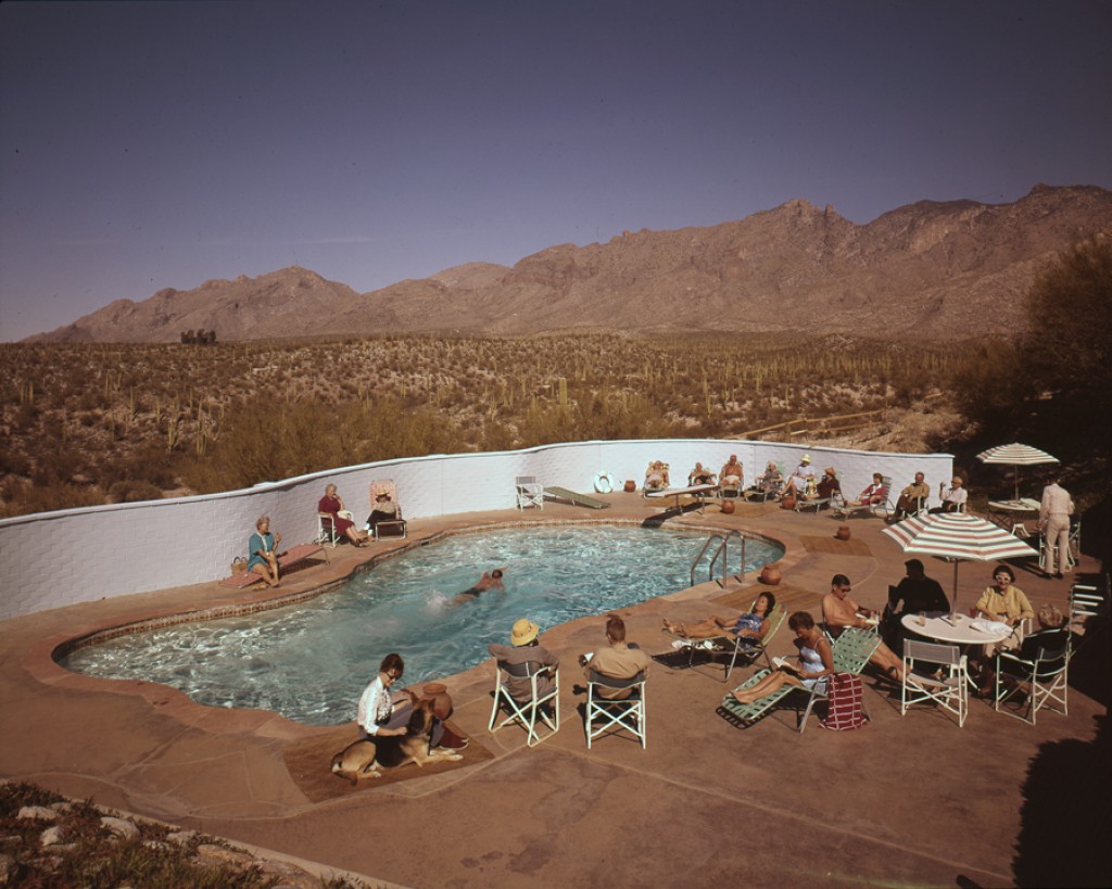 a group of people sitting around a pool