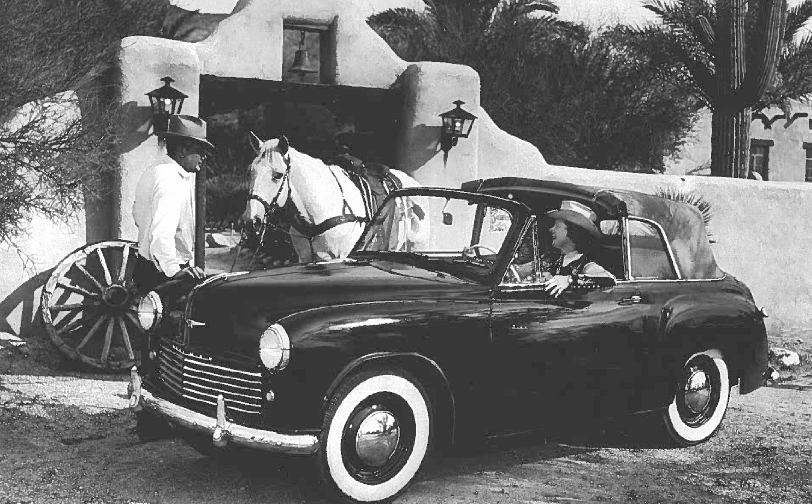 a man and woman in a convertible car