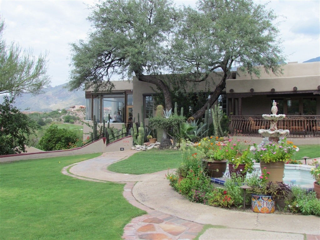 a house with a fountain and a garden