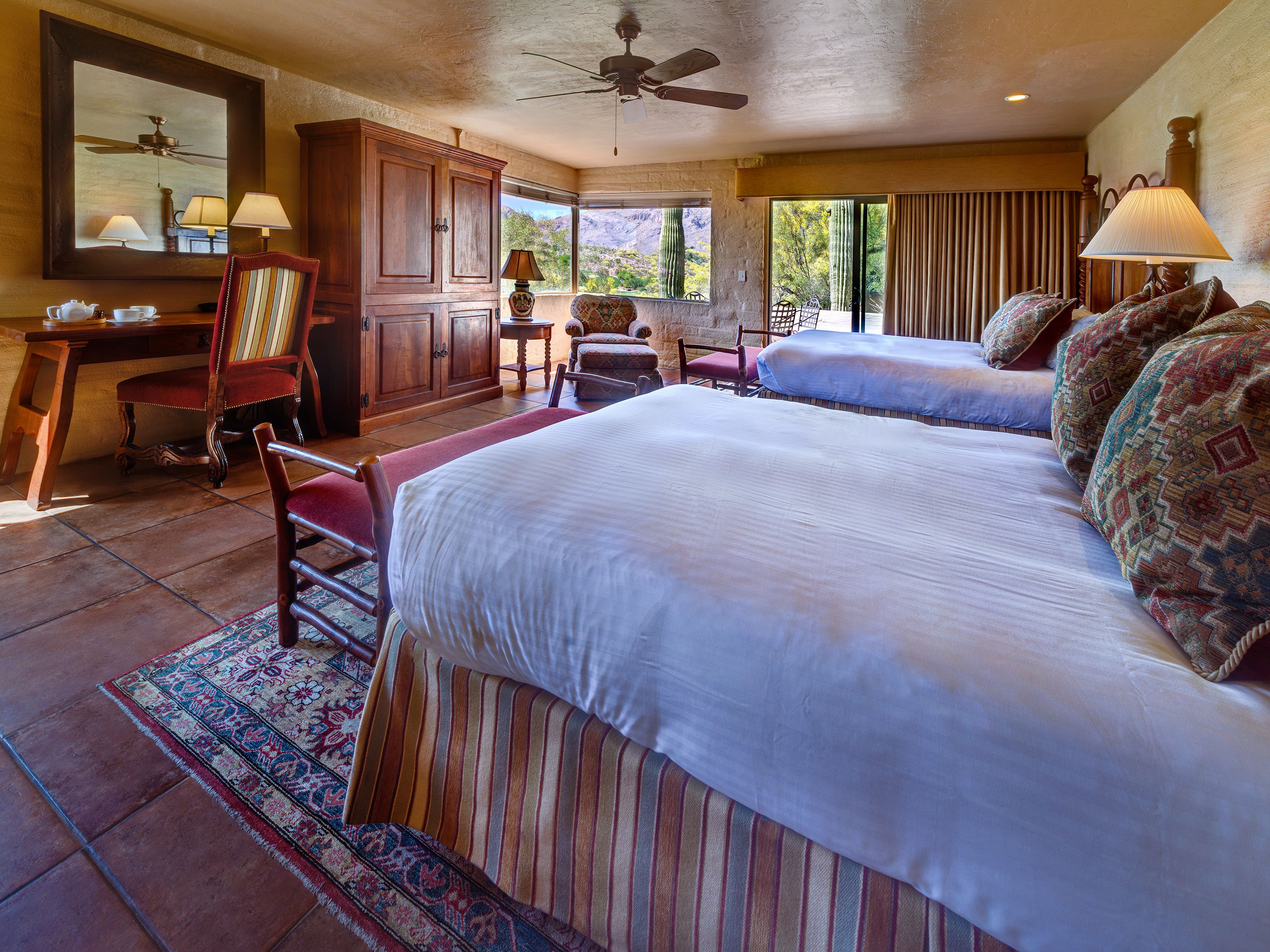 a room with two beds and a desk