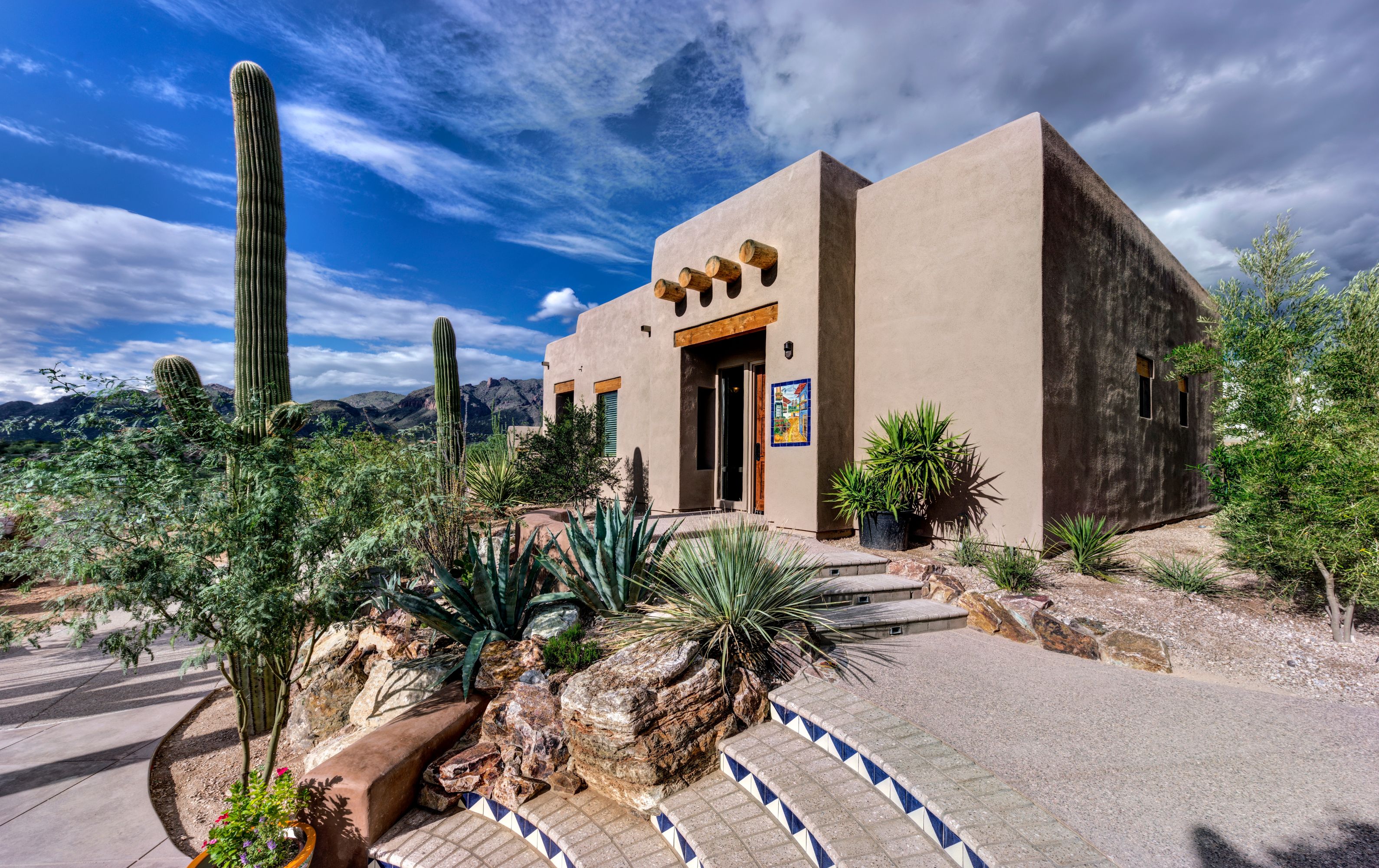 a house with cactus and a blue sky