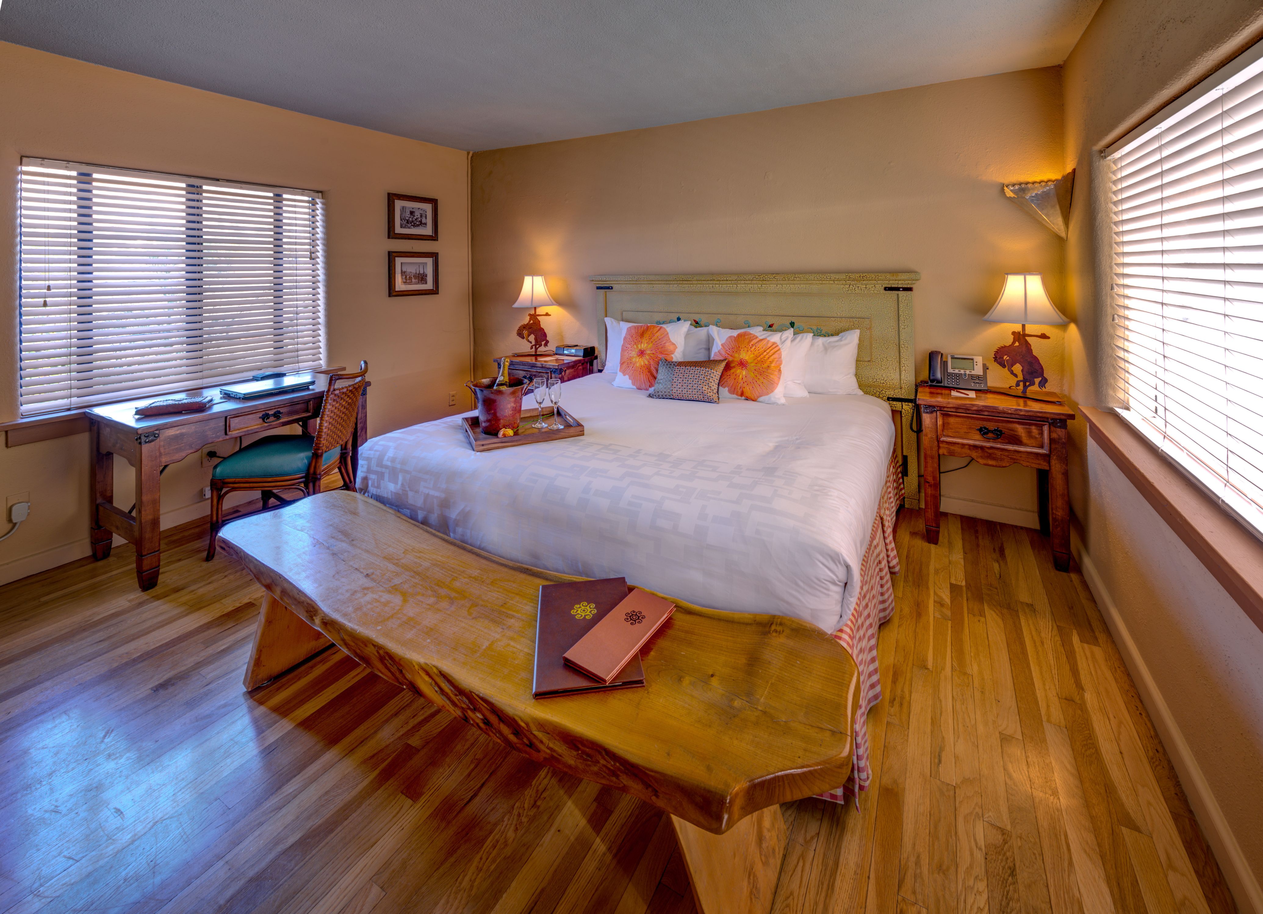 a bedroom with a wooden bench and a bed