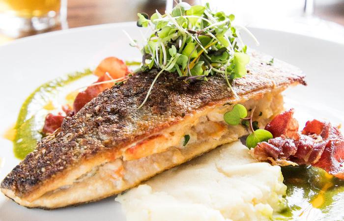 a plate of food with a slice of fish