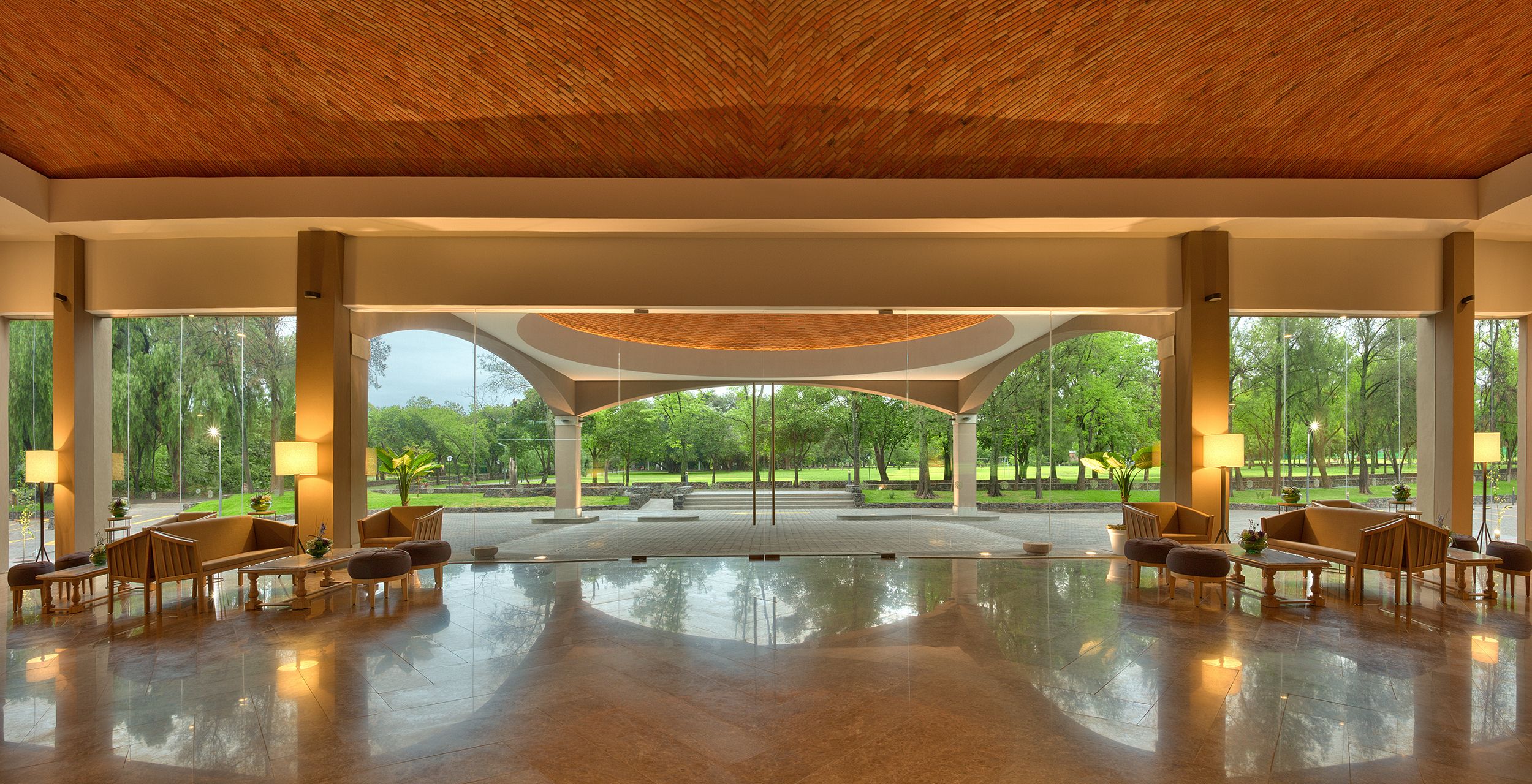 a large room with a large ceiling and a large patio with a large green lawn