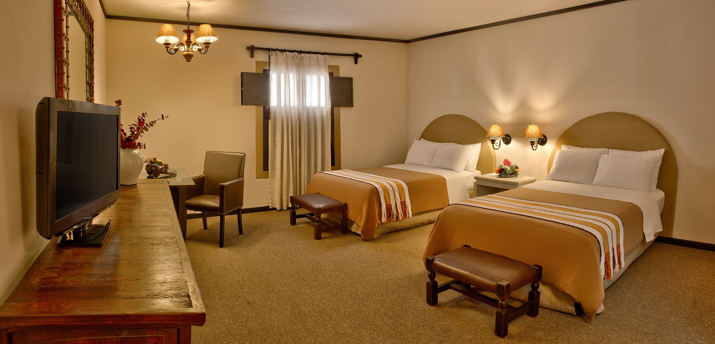a room with two beds and a fireplace