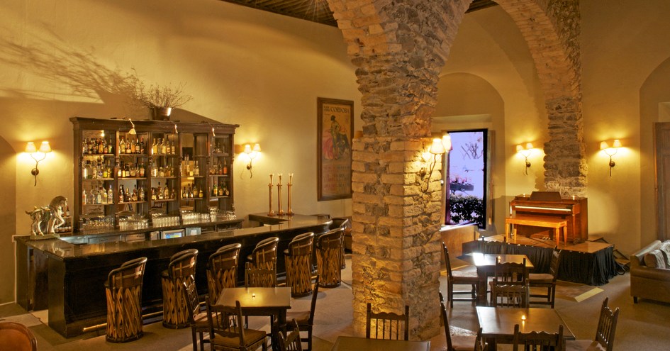 a bar with a stone column and tables