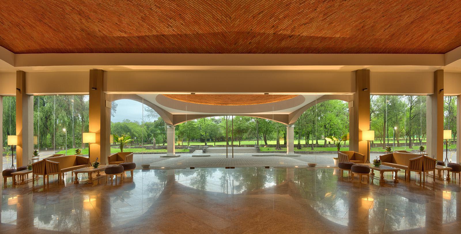 a large room with a large glass door and a large green park