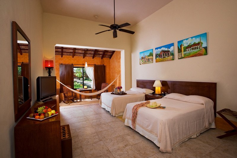 a room with two beds and a television