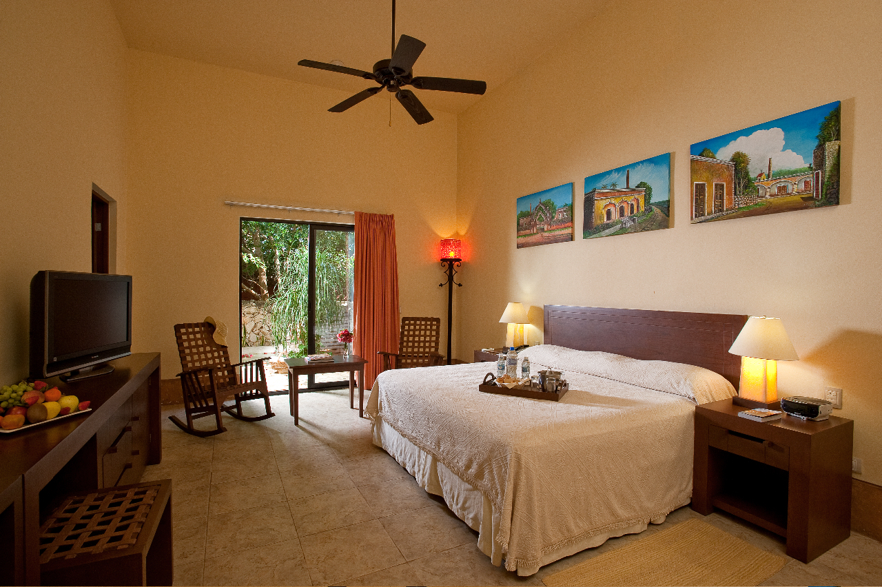 a bedroom with a bed and a ceiling fan