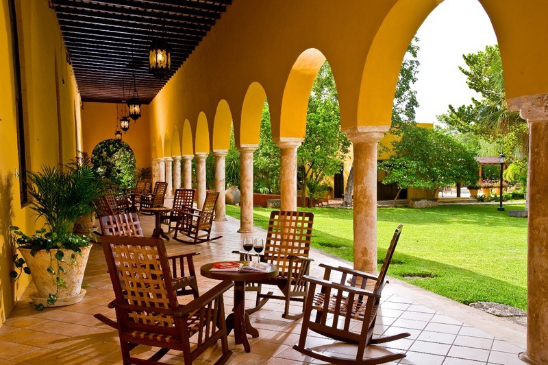 a patio with chairs and a table