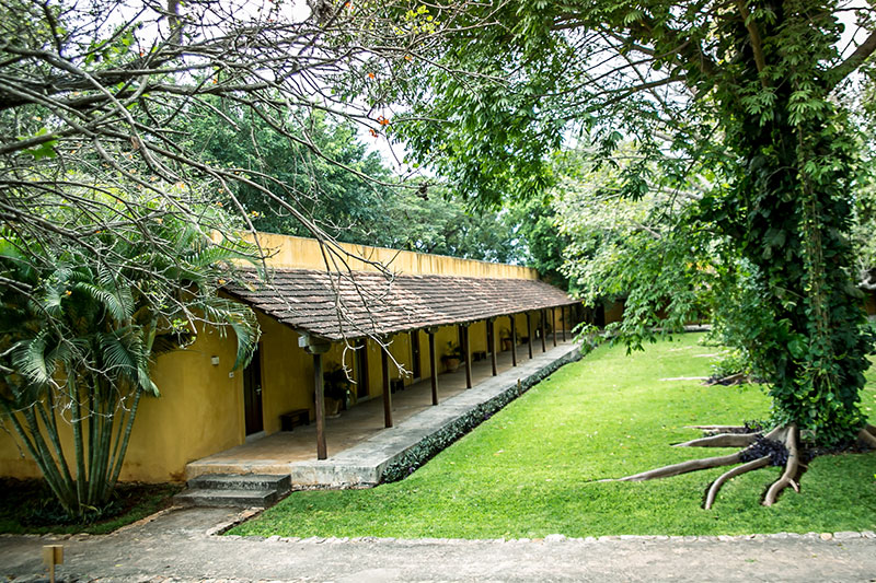a building with a porch and a lawn