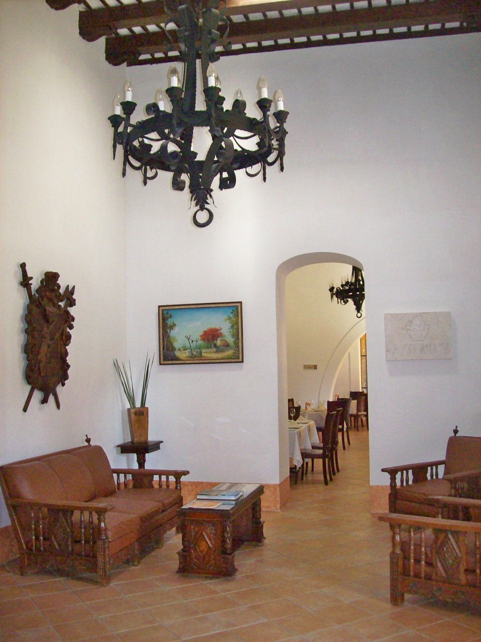 a room with a chandelier and couches