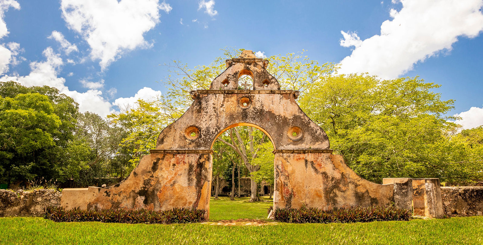 a stone arch with holes in it