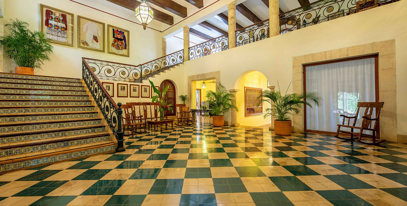 a large hall with a checkered floor and a staircase