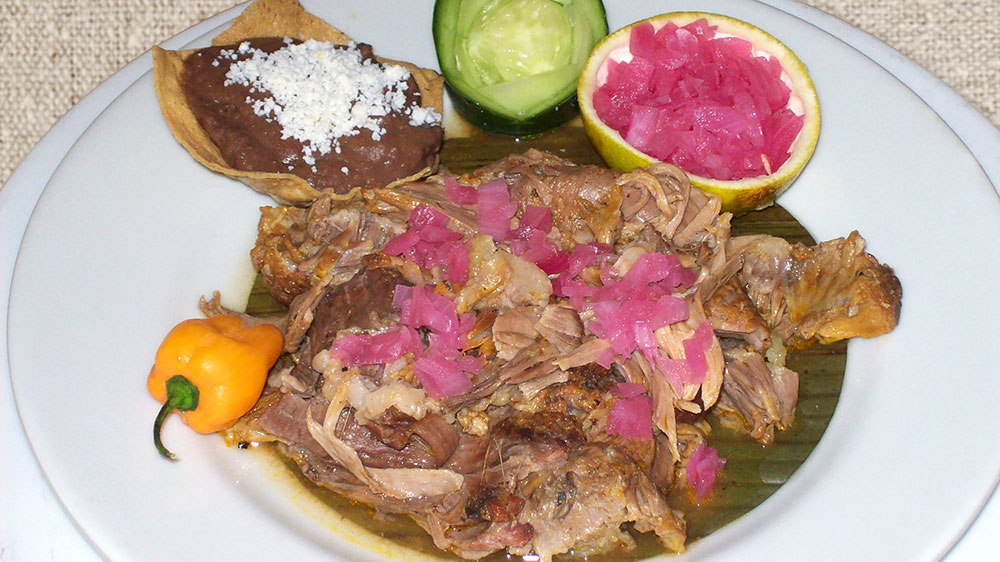 a plate of food with a slice of fruit and a slice of onion