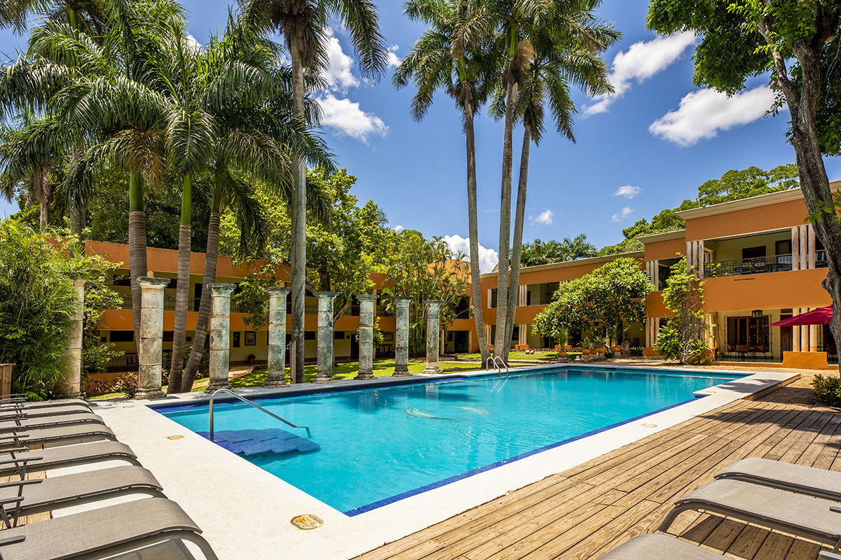 a pool with palm trees and a deck