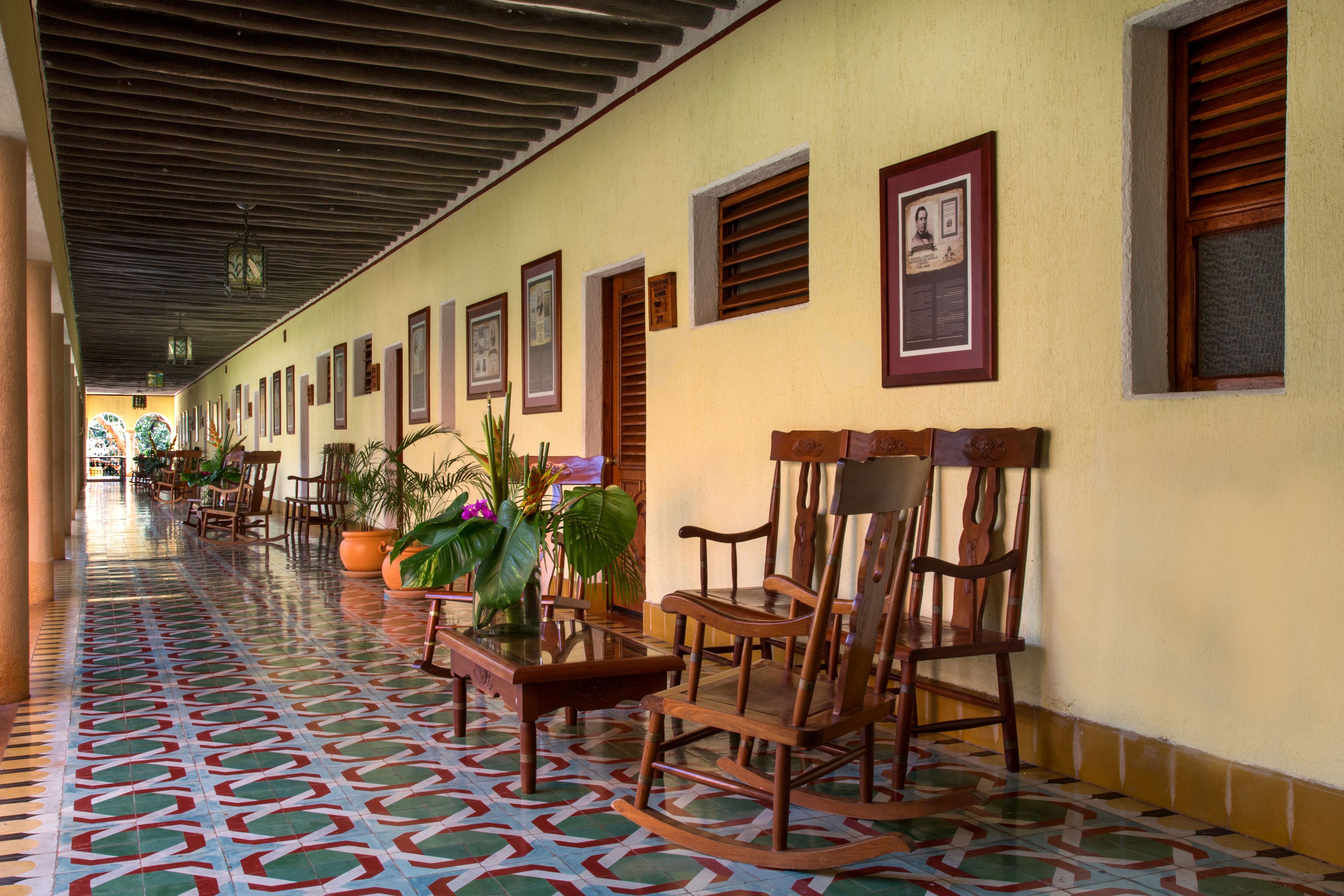 a porch with chairs and tables