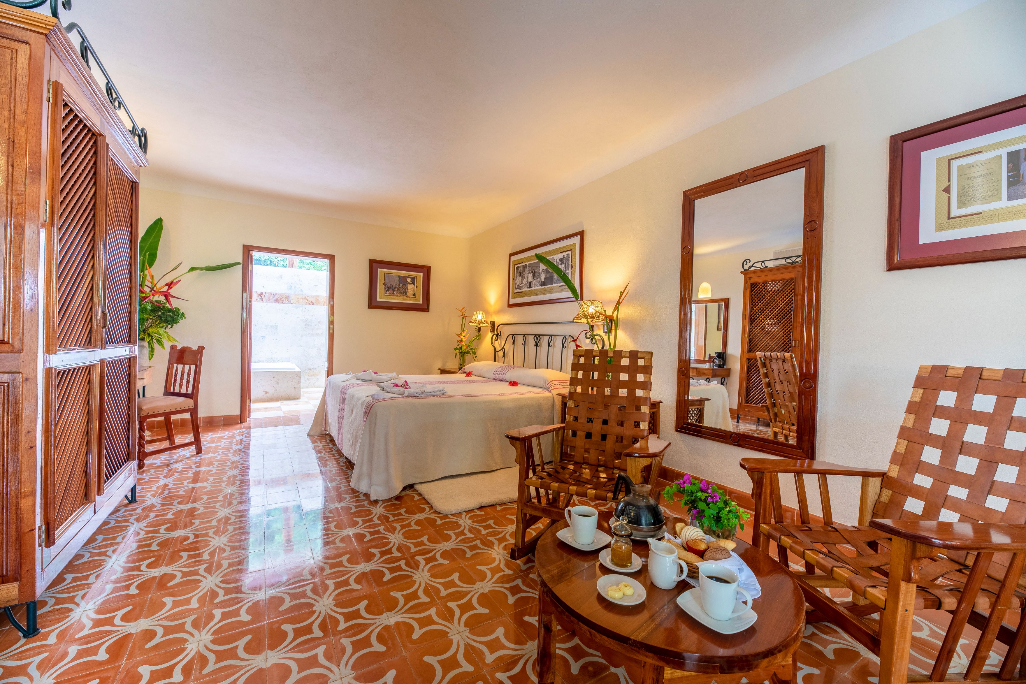 a room with a bed and chairs and a table