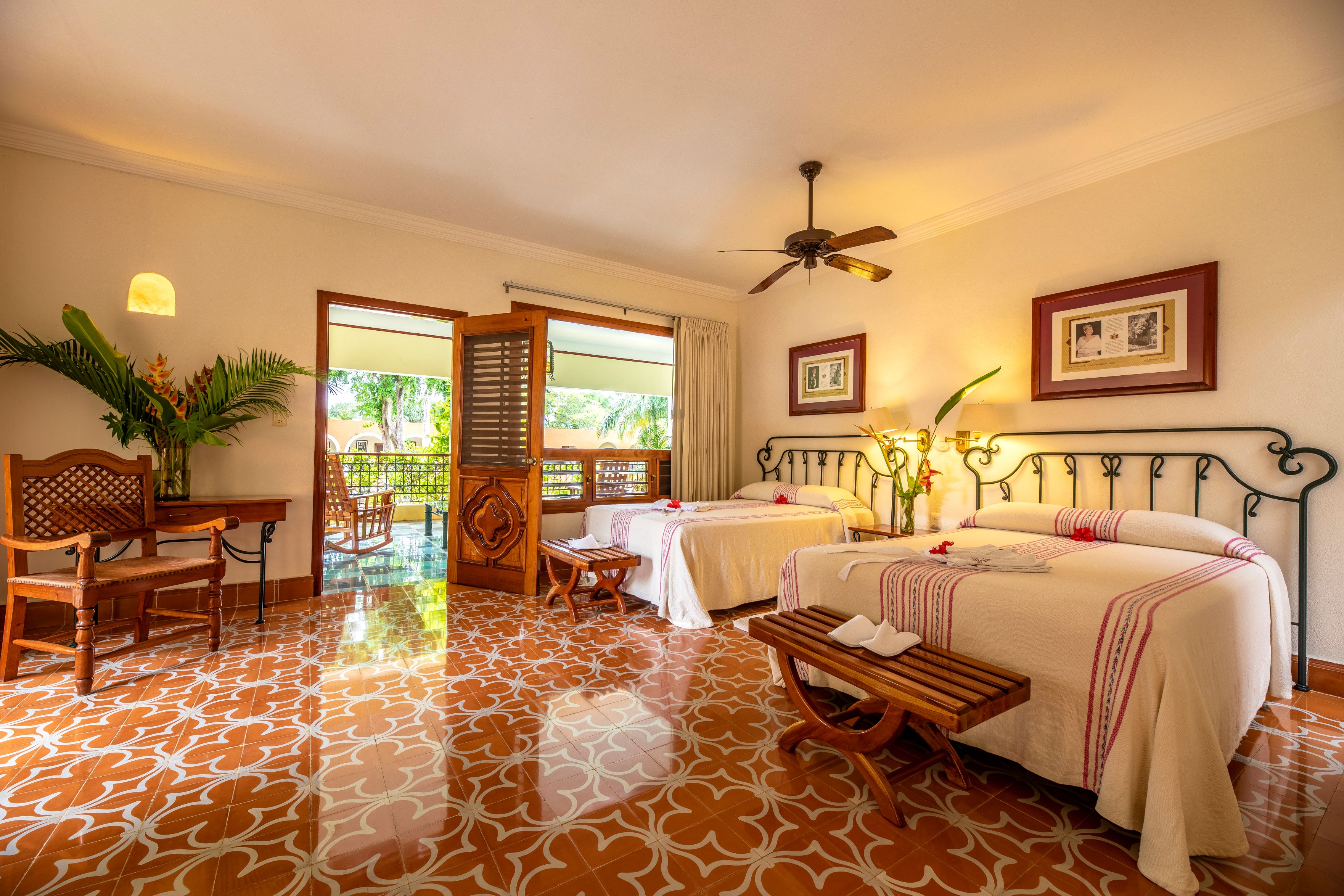 a room with two beds and a ceiling fan