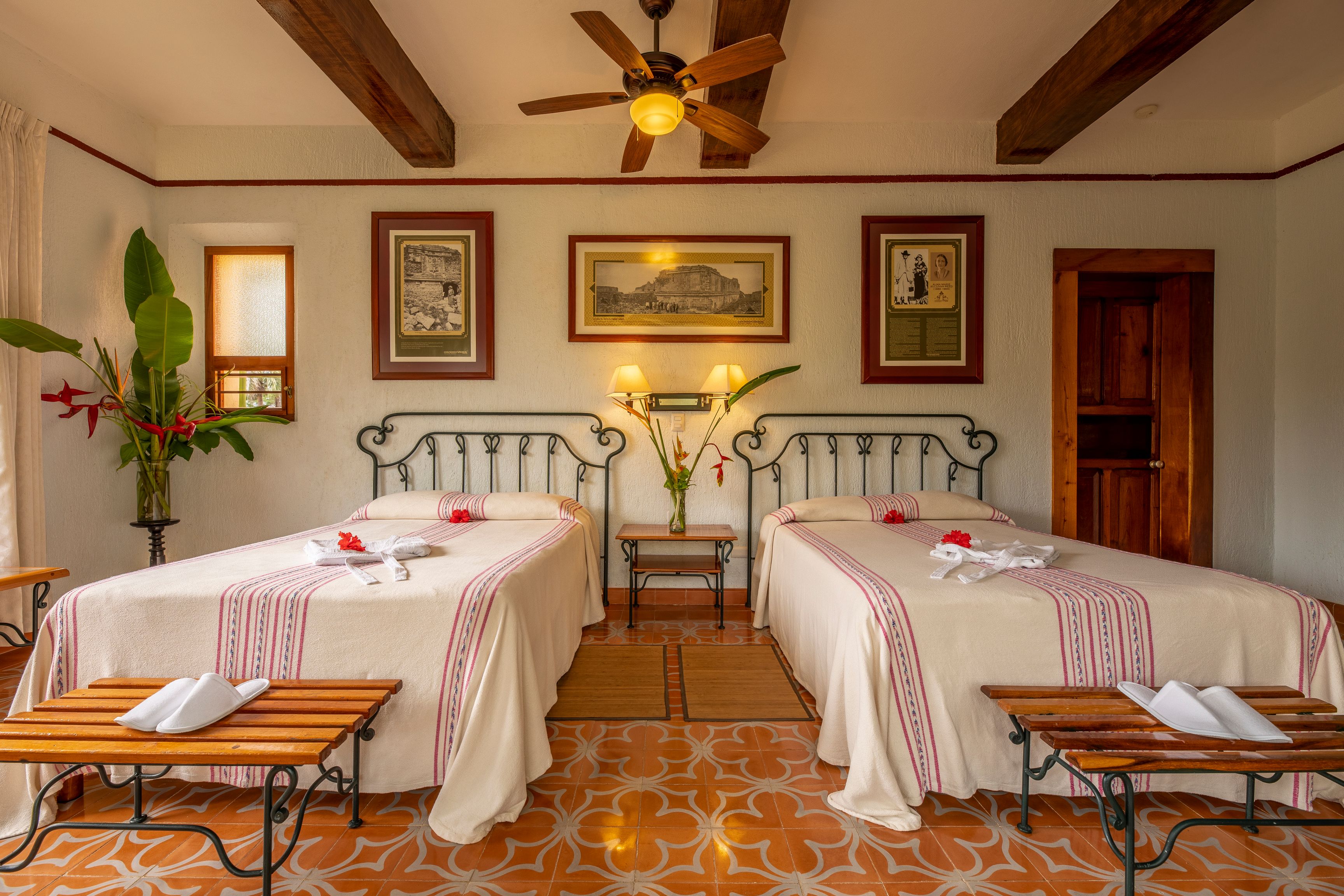 a room with two beds and a ceiling fan