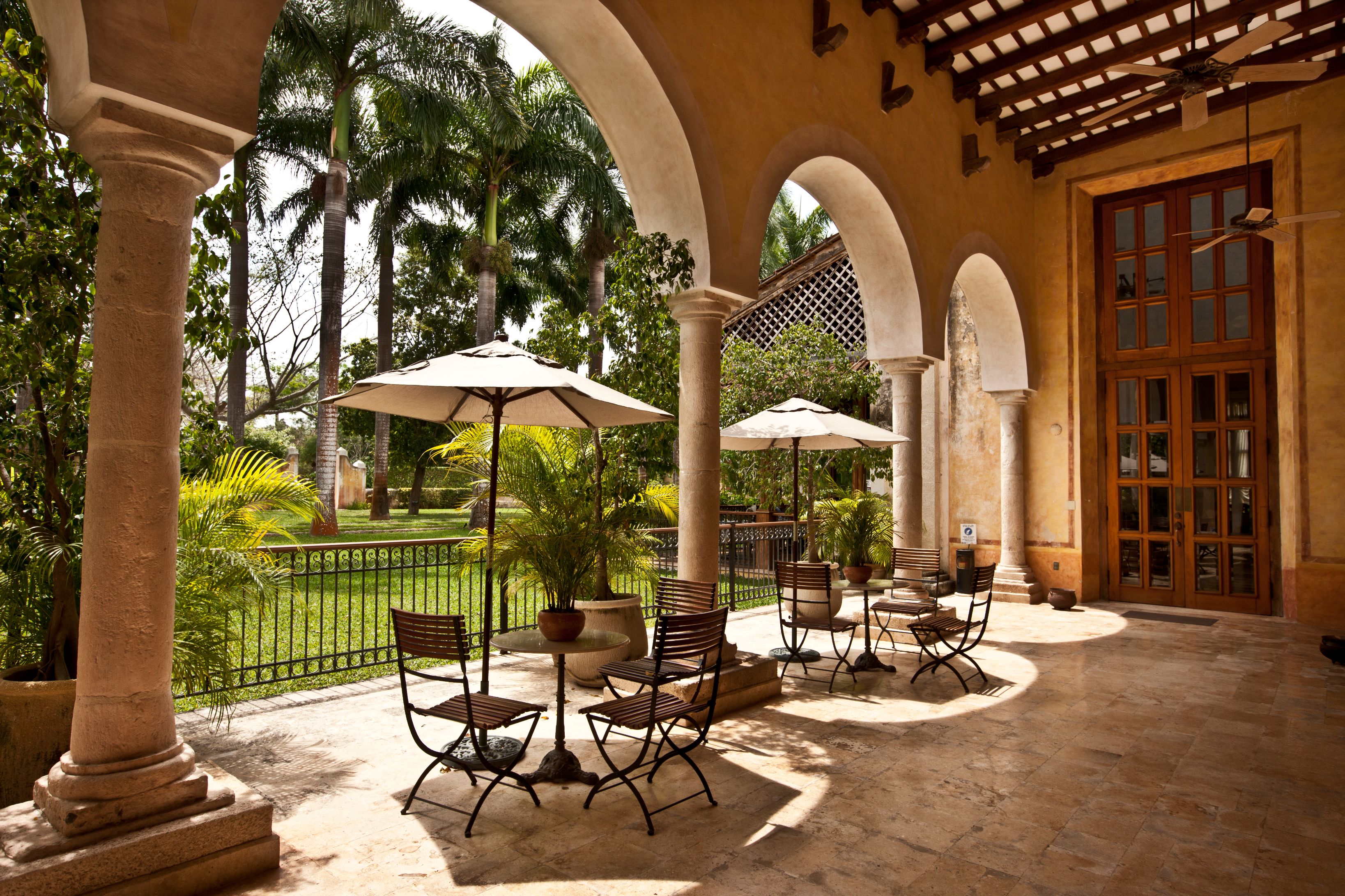 a patio with chairs and umbrellas