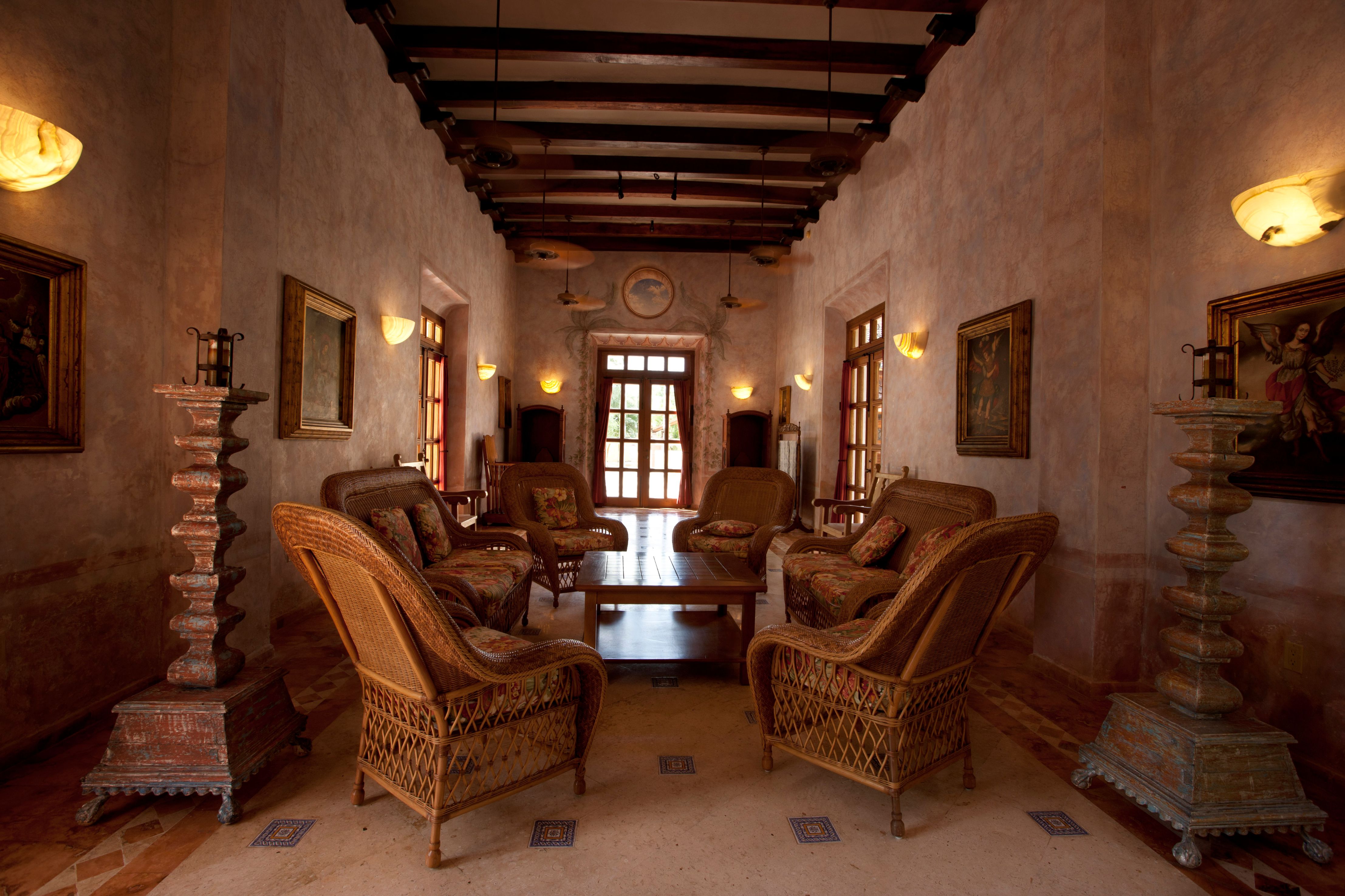 a room with wicker chairs and a table