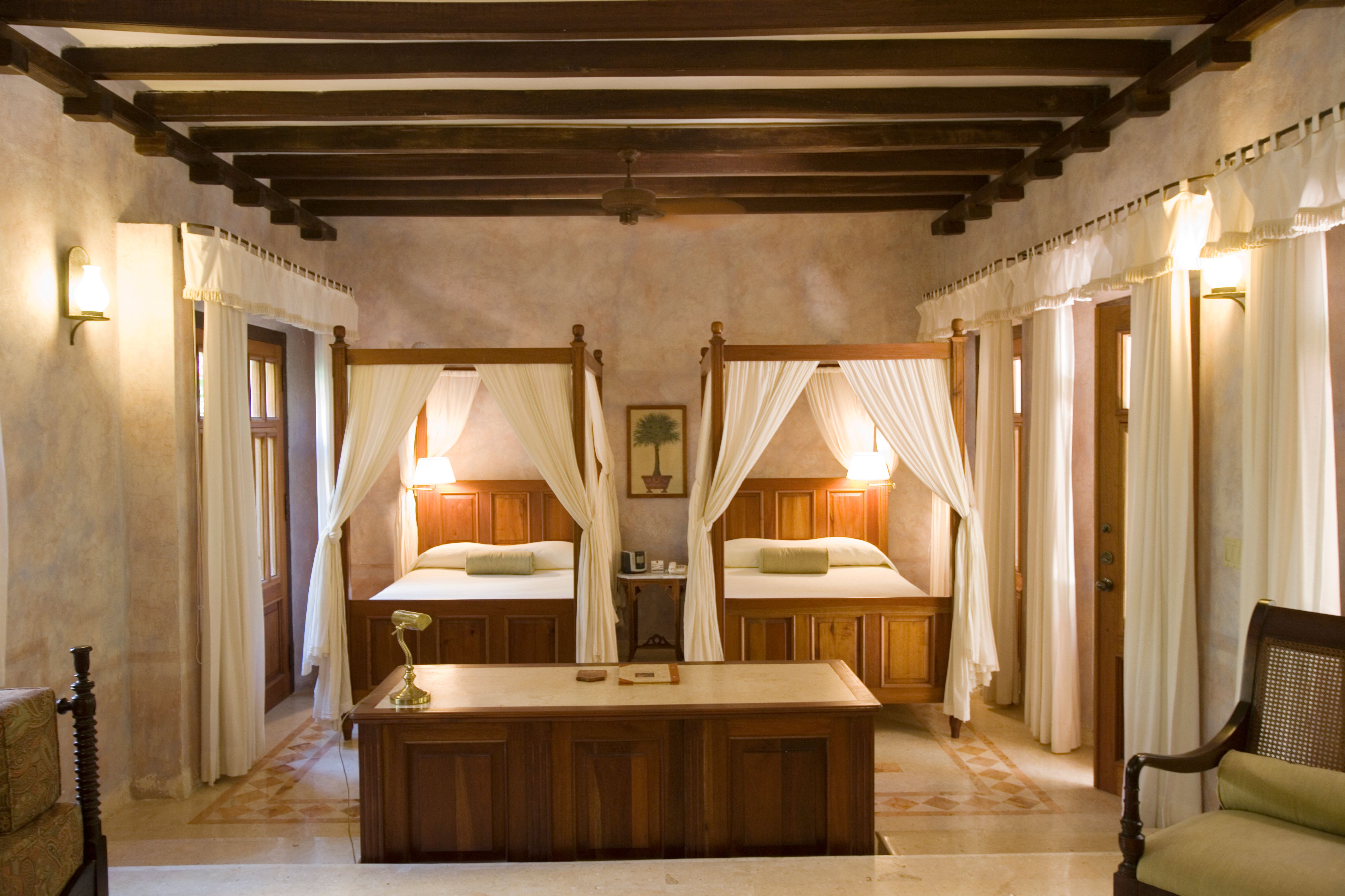 a room with four beds and a table