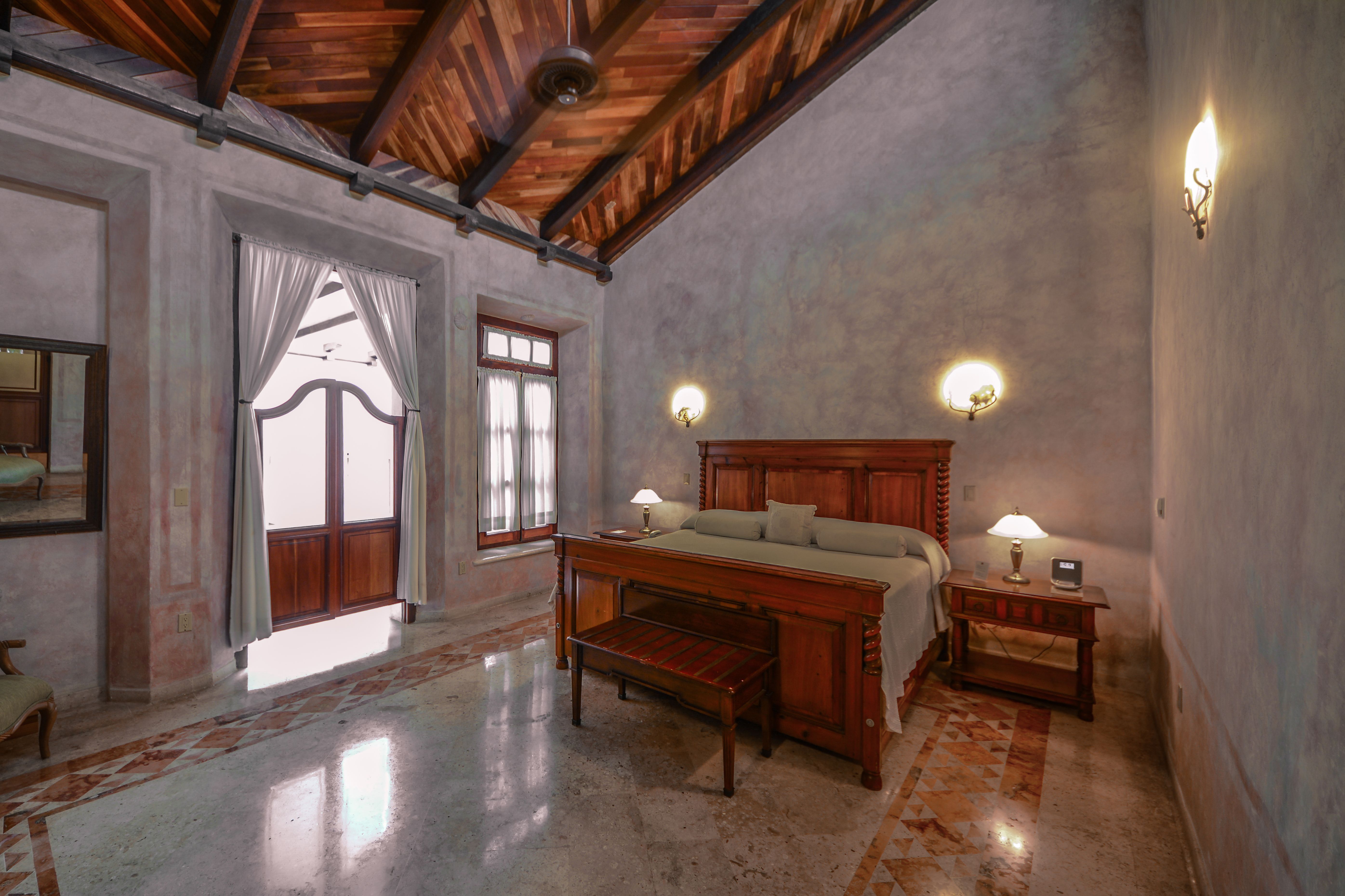 a bedroom with a bed and a bench