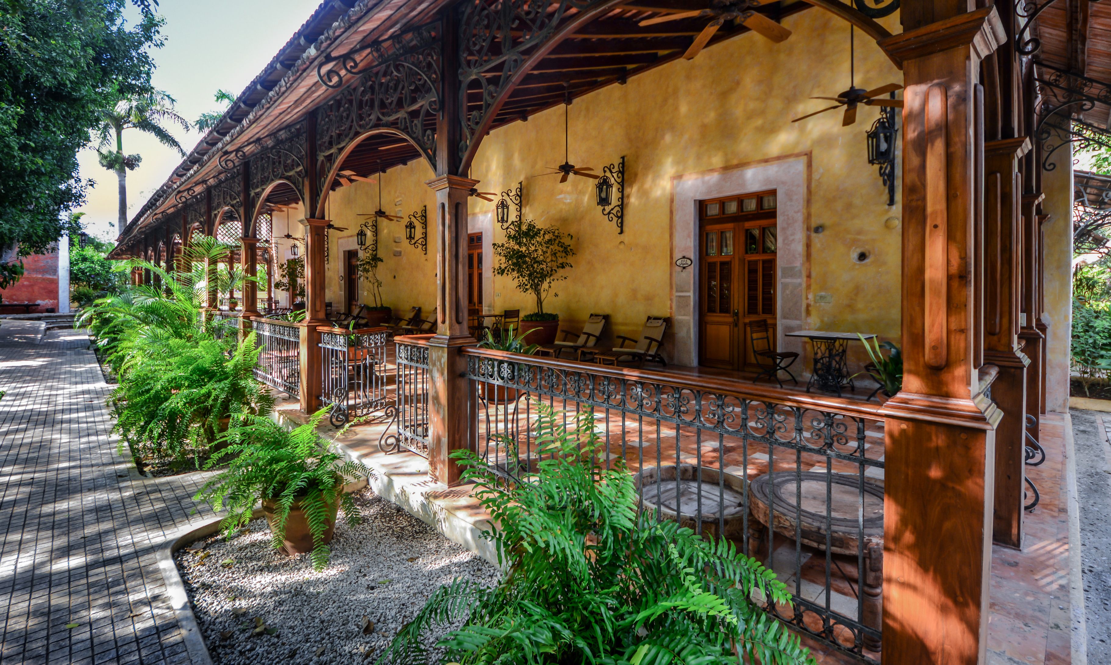 a building with a porch and plants